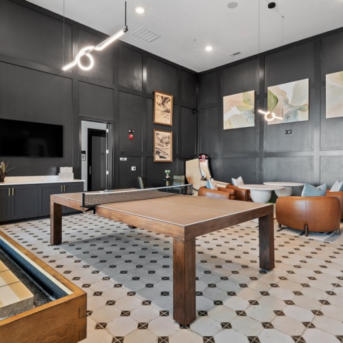 a game room with shuffleboard and ping pong
