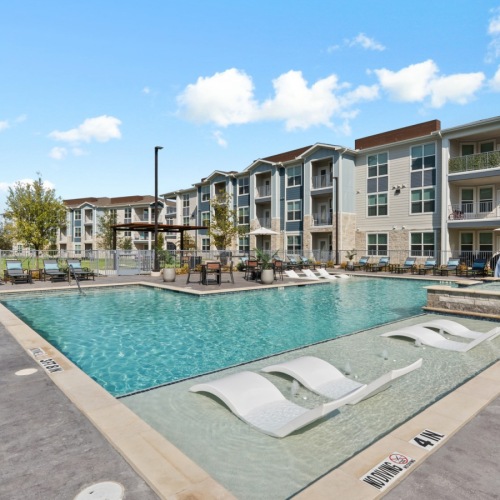 Resort-style swimming pool with lounge seating