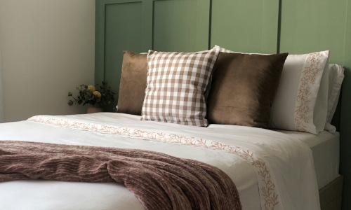 a bedroom with a bed and pillows