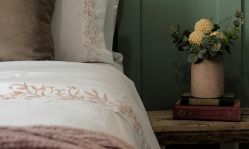 a bed with a flower pot on it